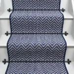 Atlantic Herringbone French Blue Stair Runner on a staircase with rods.