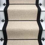 Baileys Herringbone Stair Runner with a black border.