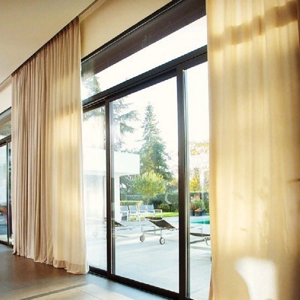 Beige sheer curtains on a motorized track