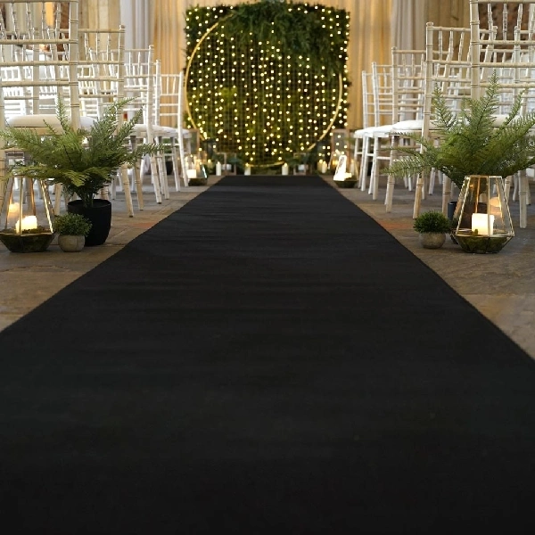 Black carpet runner leading down a wedding aisle