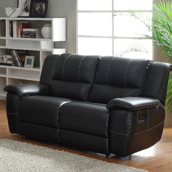 Black faux leather reclining loveseat with white contrast stitching