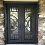 Black wrought iron double entry doors with circular geometric metalwork
