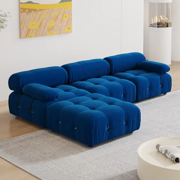 Bright blue velvet modular sofa with deep button-tufting