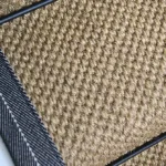 Close-up of Oriental pewter sisal stair runner with dark grey edging.