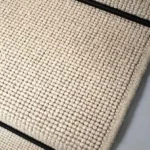 Close-up of a Charter Plain Loop Knight Stair Runner with a black border.