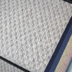 Close-up of a French Grey Small Boucle Wool Stair Runner with a stripe border.