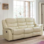 Cream faux leather three-seater reclining sofa in a bright room