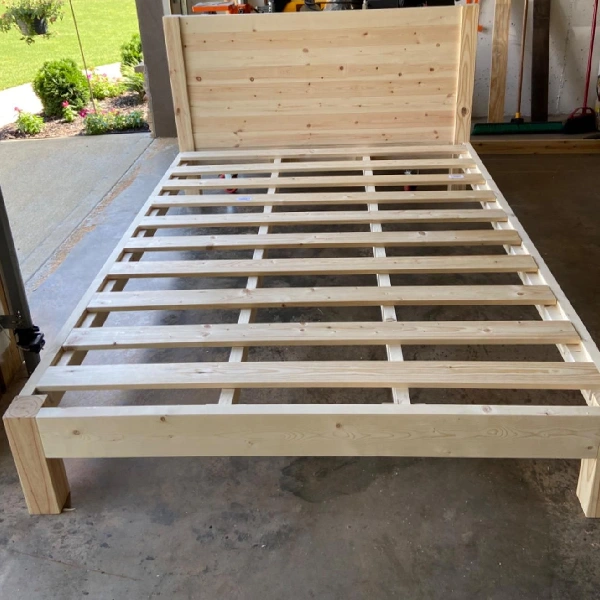 Custom-built bed frame made of unfinished light pine wood