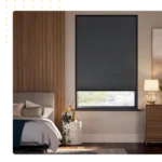Dark gray blackout cellular blind covering most of a window