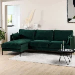 Elegant deep custom L-shaped sofa in green velvet.