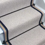 French Grey Small Boucle Wool Stair Runner with black rods and a blue and yellow stripe border.