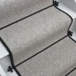 Glen Loop Wool Tungsten Stair Runner with a black binding and black stair rods.