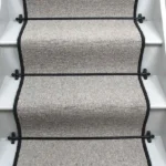 Glen Loop Wool Tungsten Stair Runner with a black binding and black stair rods. (1)