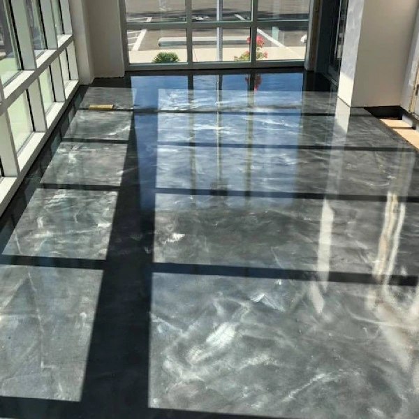 Glossy gray metallic epoxy floor with black accent lines