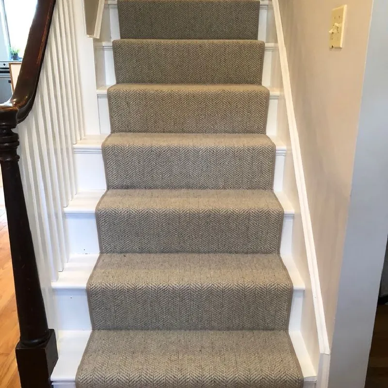 Gray herringbone stair runner with crisp white trim