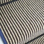 Hardy striped wool stair runner with blue edging and black stair rod.