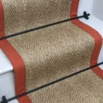Herringbone Pewter Sisal Stair Runner on stairs with a black border.
