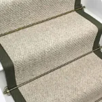 Inishowen Hessian Wool Stair Runner with a green border and brass stair rods.