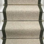 Inishowen Hessian Wool Stair Runner with a green border and brass stair rods. (1)