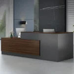 Modern dark gray and dark wood reception desk in an office