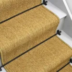 Natural mini boucle sisal stair runner with black edging and black stair rods.