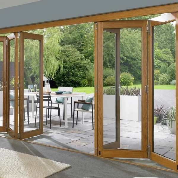 Oak wood-framed bi-fold glass doors opening onto a stone patio