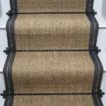 Oriental pewter sisal stair runner with dark grey edging and black stair rods.