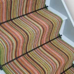 Summer Garden striped stair runner with green edging and black stair rods.