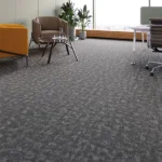 Wall-to-wall dark gray carpet with a subtle, abstract pattern