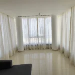 White sheer curtains covering a large window