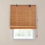 bamboo woven wood blind covering the top half of a window