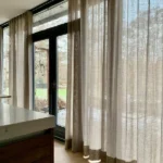 beige linen curtains covering a sliding glass door