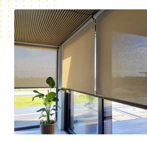 beige roller blinds on the glass window