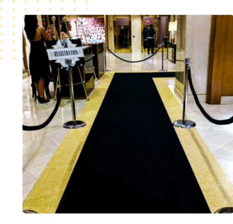 black carpet runner centered on a gold glittered floor
