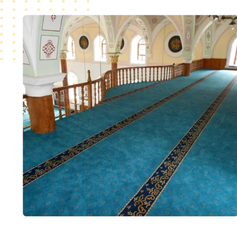 bright blue mosque carpet featuring two dark blue and gold pattern