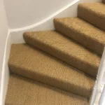 brown sisal carpet runner featuring a tight, woven texture.