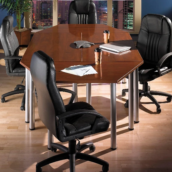 conference table with silver legs, surrounded by black leather office chairs