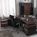 executive office with a dark wood L-shaped desk