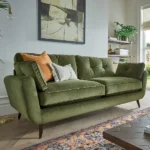 modern style olive green velvet sofa with tufted back cushions and decorative throw pillows