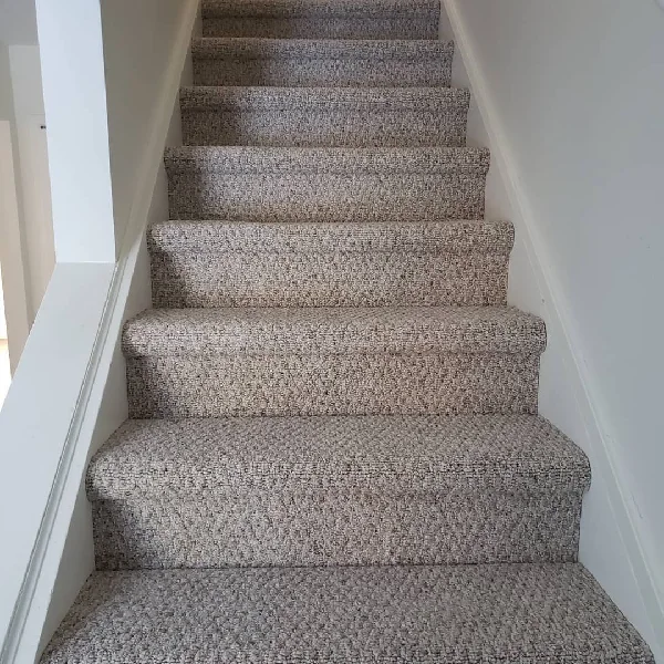 neutral-toned loop pile stair carpet