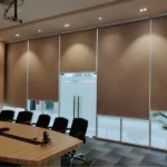 neutral-toned roller blinds covering windows