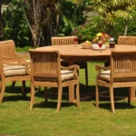 outdoor dining set with a round table and slatted armchairs