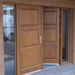panel-style wood double doors with a light brown finish