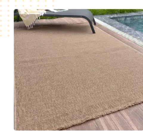 solid beige outdoor carpet placed on a deck next to a pool