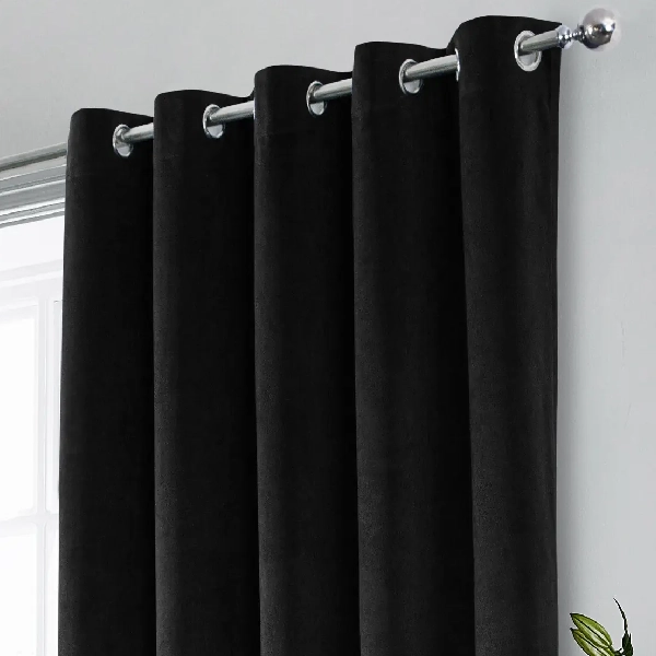 blackout curtains with silver grommets on a rod.