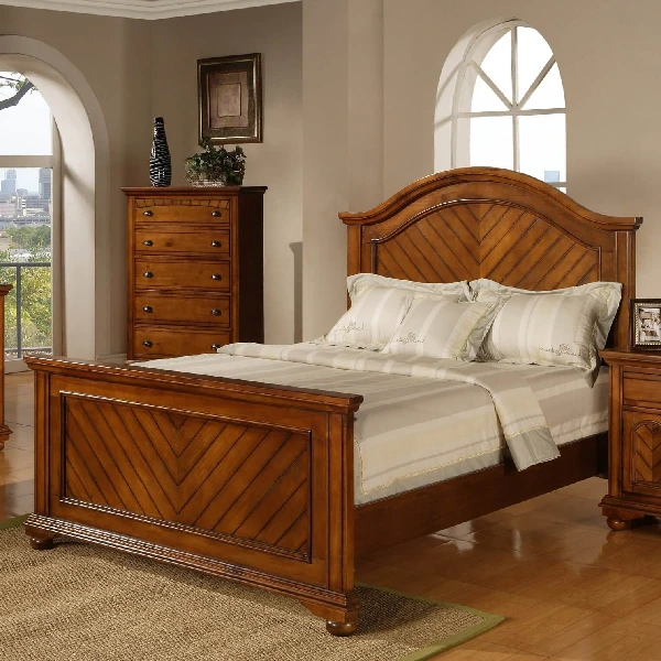 wooden bed with an arched headboard and footboard