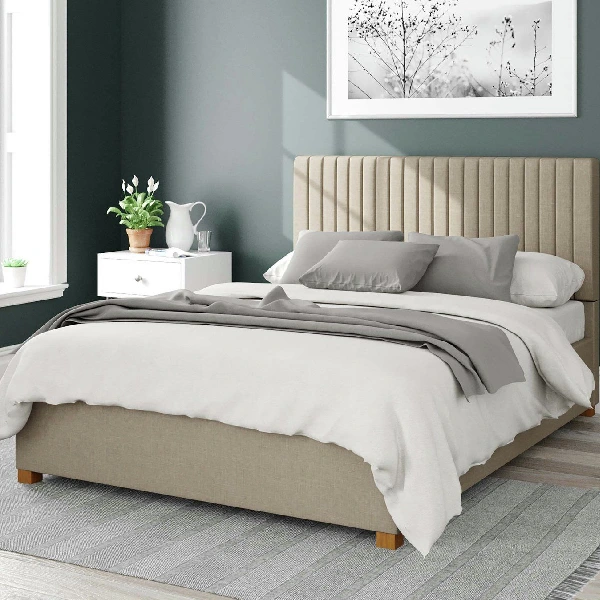 Beige upholstered ottoman storage bed with a vertically paneled headboard