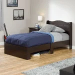 Dark wood single bed with a navy blue comforter