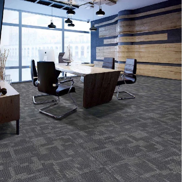 Gray patterned carpet tiles in a modern office meeting area