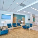 Hospital waiting area with light wood-look plank flooring.
